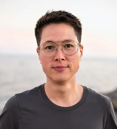 Bo Louie wearing glasses and a grey T-shirt